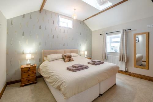 a bedroom with a large bed with two towels on it at 1 Bed in Staxton oc-w36041 in Salton