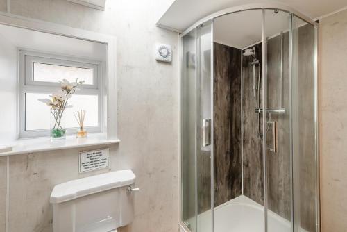 a bathroom with a shower and a toilet and a window at 1 Bed in Staxton oc-w36041 in Salton