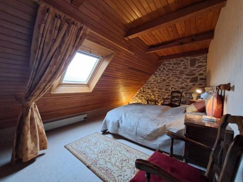 a bedroom with a bed and a window in a room at Nouveau - Maison Nierveze proche Lioran in Thiézac