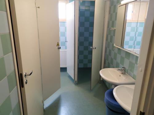 a bathroom with a sink and a toilet at RIEKKO Hostel in Kuusamo