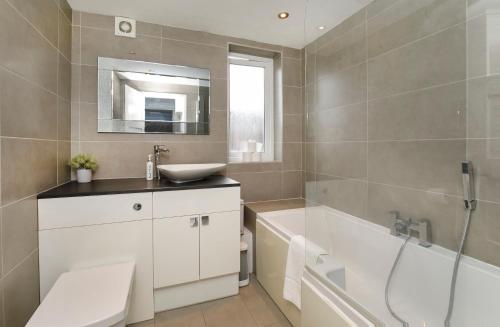 a bathroom with a white tub and a sink and a bath tub at Holgate Lodge in York