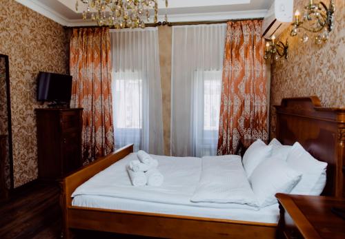 a bedroom with a bed with two towels on it at Royal Historical Boutique Hotel in Baku