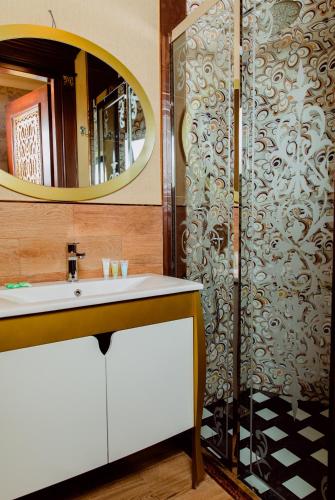 a bathroom with a sink and a mirror at Royal Historical Boutique Hotel in Baku