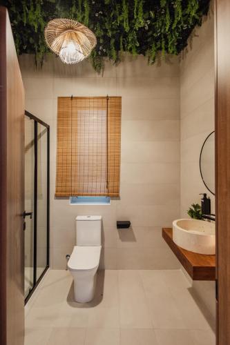 a bathroom with a toilet and a sink at St Julians`s Boho Apartments in Is-Swieqi