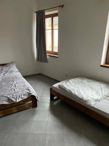 a bedroom with two beds and a window at Ubytování Jimramov in Jimramov