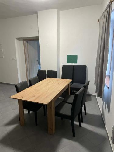 a wooden table and chairs in a room at Ubytování Jimramov in Jimramov