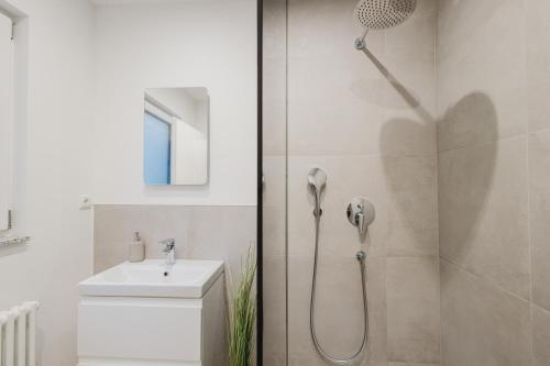 a bathroom with a shower and a sink at Stadtblick Passau Apartment in Passau
