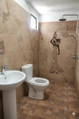 a bathroom with a toilet and a sink at DenbyD in Tennekumbura