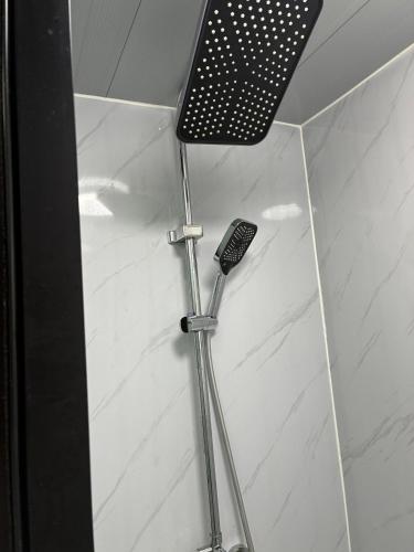 a remote control in a shower in a bathroom at Beautiful Pradise 1 in Penfield