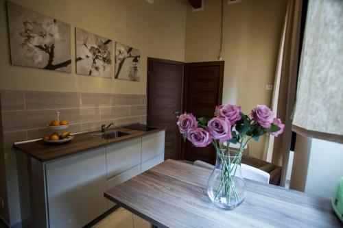 a vase of flowers on a table in a kitchen at Stampace Apartments in Cagliari