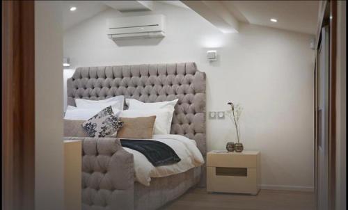 a bedroom with a large bed with a large headboard at Central luxury duplex in Cannes