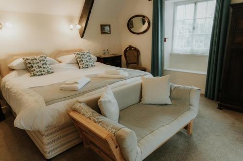 a bedroom with a large bed and a couch at The Half Moon Inn in Dean