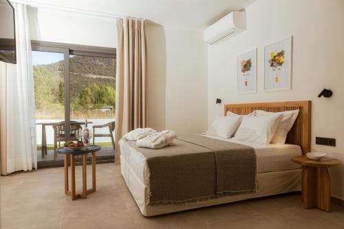 a bedroom with a bed and a balcony at Villas Marajo in Skala Potamias