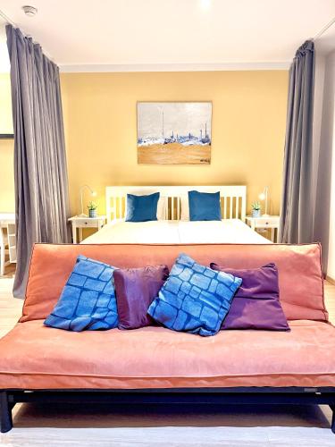 a couch with pillows on it in a bedroom at VibeStudio A2- Central Vienna 1090 - 50m2 - Self Check-In - AC in Vienna