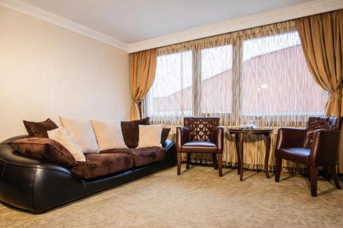 ein Wohnzimmer mit Ledersofa und Sesseln in der Unterkunft Grandwork Hotel in Dikmen