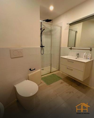 a bathroom with a toilet and a sink and a shower at VVR6 Rooms by Homes in Ancona in Ancona