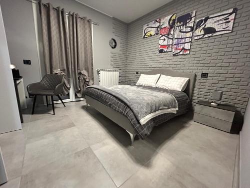 a bedroom with a bed and a brick wall at B&B Art in Silvi Marina