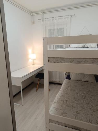 a bedroom with a bunk bed and a desk at Apartment T&M in Trogir