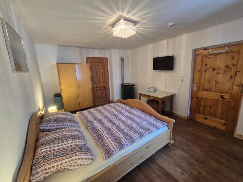 a bedroom with a bed and a table and a television at Spiss 21 in Spiss