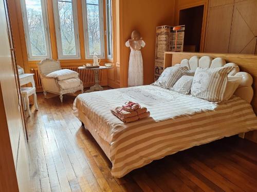a bedroom with a large bed and a dress on a dummy at Chez Madame in Dijon