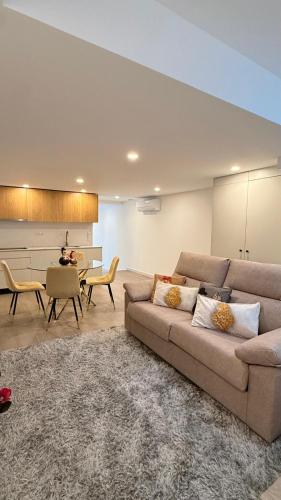 a living room with a couch and a table at Casa Portela Viana do Castelo in Viana do Castelo