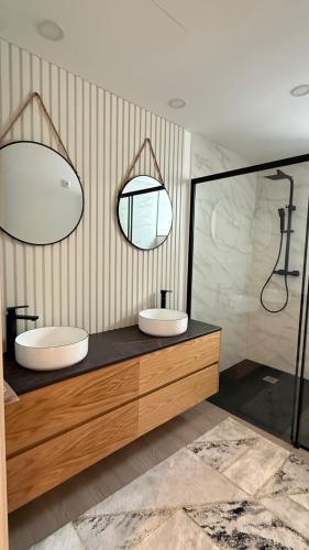 a bathroom with two sinks and a mirror at Casa Portela Viana do Castelo in Viana do Castelo