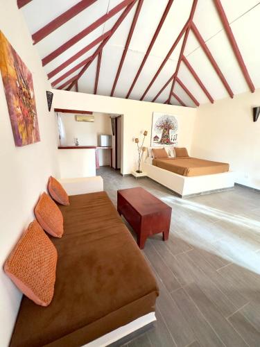a large room with a bed and a couch at Bandam Lodge in Ngaring