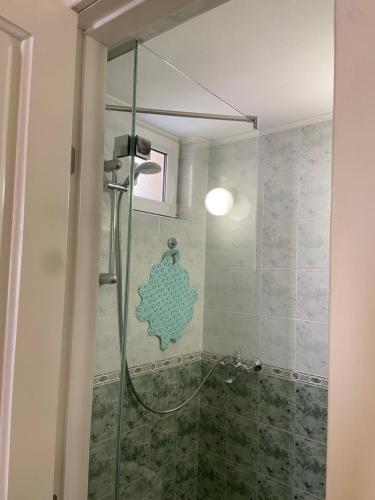 a shower with a glass door in a bathroom at Art Studios Elsor in Burgas