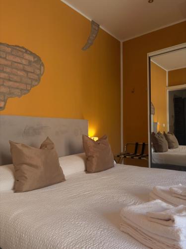 a bedroom with a large white bed with pillows at Forum Guest House FREE Private Parking in Parma
