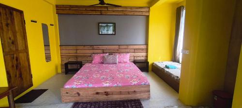 a bedroom with a bed in a yellow room at West corner homestay in Shillong