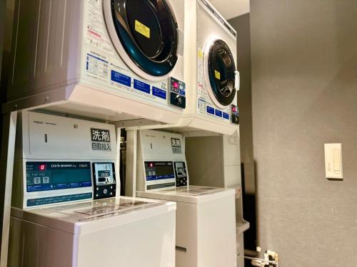 two washing machines are on display in a room at Henn na Hotel Maihama Tokyo Bay in Urayasu