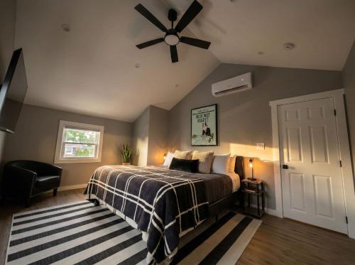 a bedroom with a bed and a ceiling fan at Sleek Modern Villa - Centrally Located in Wilmington
