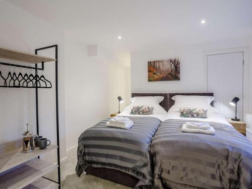 a bedroom with a large bed with two pillows at 3 Bed in Harrogate oc-86490 in Harrogate