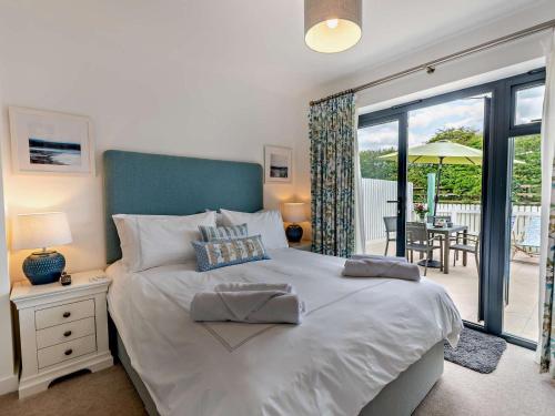 a bedroom with a bed with a view of a patio at 2 Bed in Bideford oc-91748 in Northam