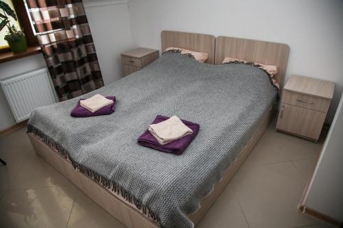 a bedroom with a bed with two pillows on it at Minihotel Freedom in Lviv