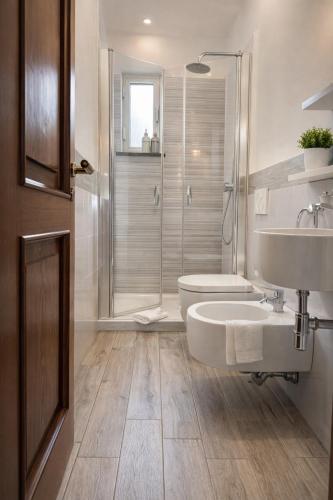 a bathroom with a toilet and a sink and a shower at Enjoy Home Sorrento in Sorrento
