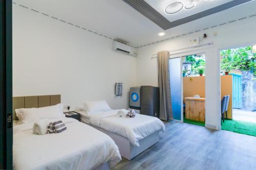 Postel nebo postele na pokoji v ubytování Atoll Suite