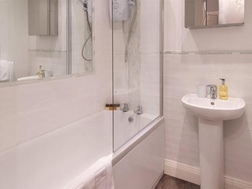 a white bathroom with a shower and a sink at 1 Bed in Harrogate oc-hh080 in Harrogate