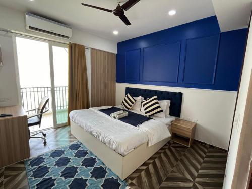 a bedroom with blue cabinets and a large bed at Azure by Grehstay in Noida
