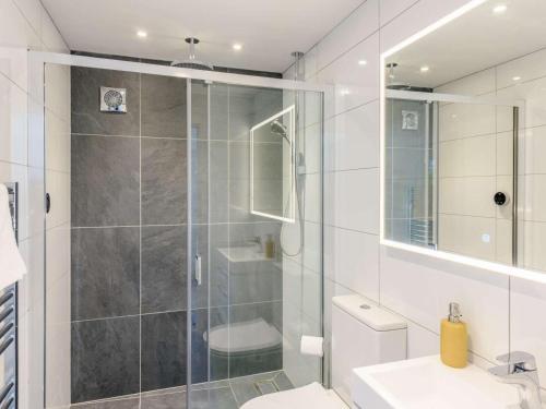 a bathroom with a shower and a toilet and a sink at 1 Bed in Woolacombe oc-82341 in Woolacombe
