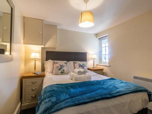 a bedroom with a bed with two towels on it at 3 Bed in Braunton oc-87107 in Croyde