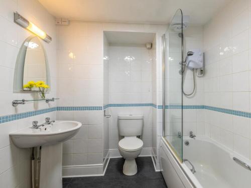 a bathroom with a toilet and a sink and a shower at 3 Bed in Braunton oc-87107 in Croyde
