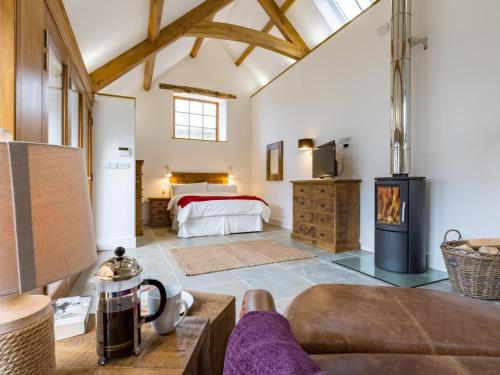 a large room with a bed and a fireplace at 4 Bed in Braunton oc-62949 in Croyde