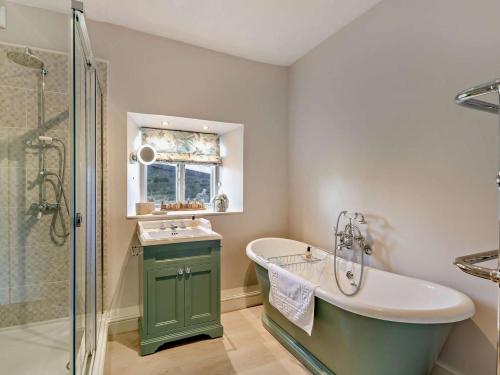 a bathroom with a tub and a sink and a shower at 3 Bed in Leyburn oc-g0185 in Carlton