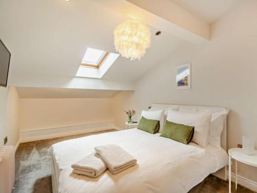 a bedroom with a white bed with towels on it at 3 Bed in Harrogate oc-91269 in Summer Bridge