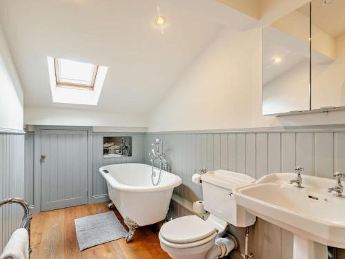 a bathroom with a toilet and a tub and a sink at 3 Bed in Harrogate oc-91269 in Summer Bridge
