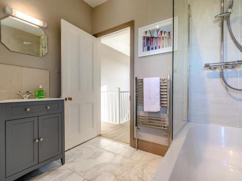 a bathroom with a walk in shower and a glass shower stall at 3 Bed in York oc-79525 in Deighton