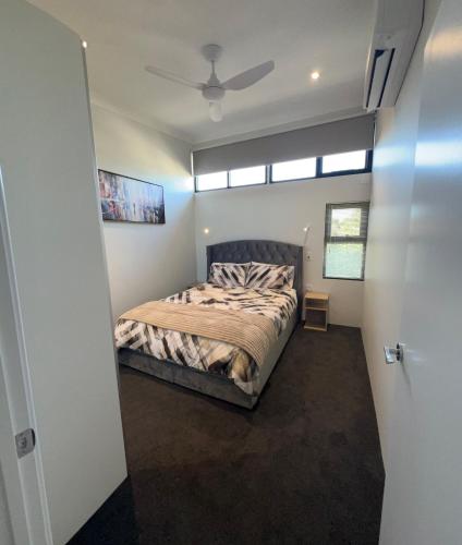 a bedroom with a bed and a ceiling fan at il Villinno on Dalton - Great Location in Mosman Park