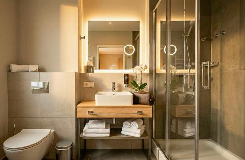 a bathroom with a sink and a shower at H24 Parkhotel Thale in Thale