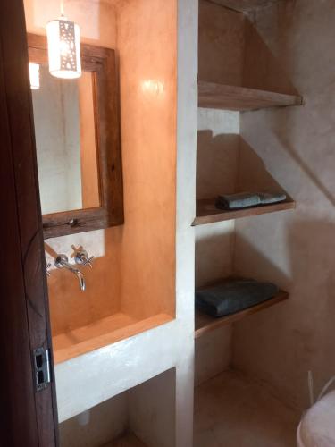 a bathroom with a sink and a mirror at Marlin room in Watamu